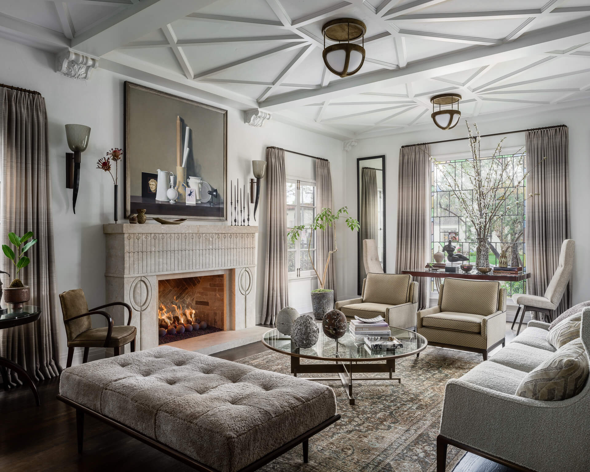 Neutral living room with fireplace, sculptural ceiling and upholstered seating in a Los Angeles home